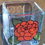 "RED FLOWER" 3" candle holder painted with a delicate rose design. Piece was baked for added durability.