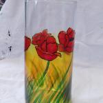 "POPPIES" Brilliant red poppies on layers of warm colors painted on a clear 7" tall clear vase. The piece was then baked for added durability.
